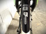 a close up view of a bike parked in a parking lot