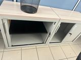 a trash can sitting on top of a cabinet in a bathroom