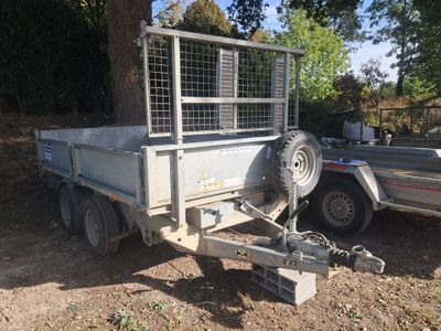 a trailer with a trailer attached to it in the dirt
