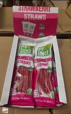 two packages of strawberries in a box on a table