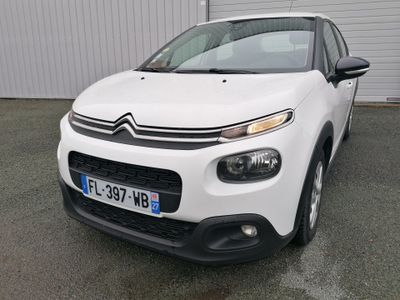 the front of a white citrole parked in front of a building