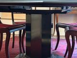 an image of a dining room with a table and chairs