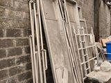 many pieces of furniture that are stacked up against a brick wall