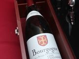 a bottle of wine in a wooden case on a table