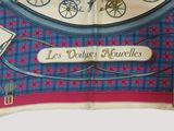 a blue and pink scarf with a clock on it