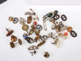 a pile of assorted jewelry on a white surface