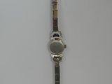 a close up of a wrist watch on a white surface