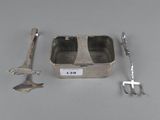 a small tin with a fork, knife, and spoon in it