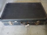 a black suitcase sitting on the floor with a tag on it