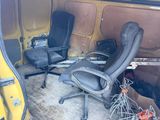 two office chairs in the back of a van