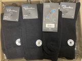 three pairs of men ' s black socks in a cardboard box