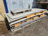 a pile of pallets sitting outside of a building