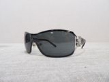black sunglasses with silver accents on a white surface