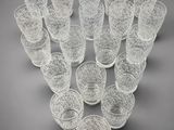 a group of glasses sitting on top of a table next to each other