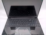 a black laptop with a black keyboard sitting on a white surface