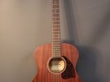 a close up of an acoustic guitar on a gray background
