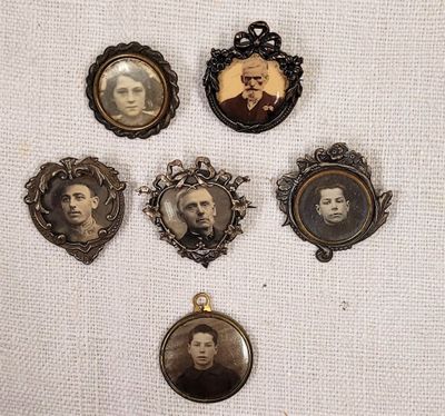 six antique portraits of men and women are displayed on a white cloth