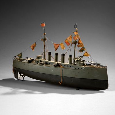 a small model of a boat with flags on it