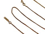 several different types of gold chains on a white background