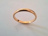 a close up of a gold ring on a white surface