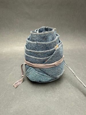 a ball of yarn wrapped around a string on the ground