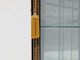 a glass display case with a clock on it