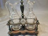 three glass vases and a candle holder on a table