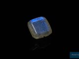 an image of a blue and white stone on a black surface
