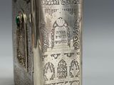 an old silver box with a picture of a man and a woman on it