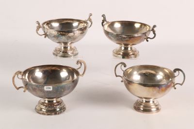 three silver plated bowls with handles and handles on a white surface