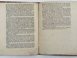 a book open on a white table with a black border