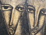 painting of three faces on a concrete wall with black and white paint