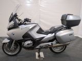 a picture of a silver and black motorcycle parked in a garage