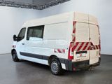 a white van with red stripes parked in a room