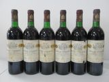six bottles of wine are lined up in a row on a table