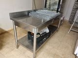 a stainless steel table with a grill on top of it
