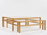 an image of a glass coffee table with three wooden legs