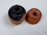 two wooden spools sitting on a white surface