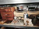 a shelf that has a clock and other items on it