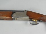 an old shotgun with a wooden handle and a metal barrel