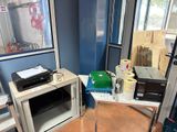 a microwave and a printer on a table in a room
