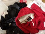 a pile of clothes in a plastic bag on the floor