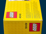 yellow box of legos on a blue background with a black background
