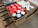 many cans of paint in a box on a pallet