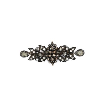 a close up of a black and white diamond broochle