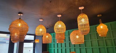 many lights hanging from the ceiling of a restaurant