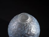 a clear glass vase with a silver design on it