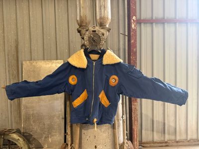 a mannequin of a man wearing a blue jacket and a hat