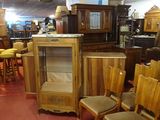 many chairs and a cabinet in a room with a lot of furniture