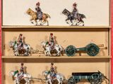 a lot of toy soldiers riding on horses and carts